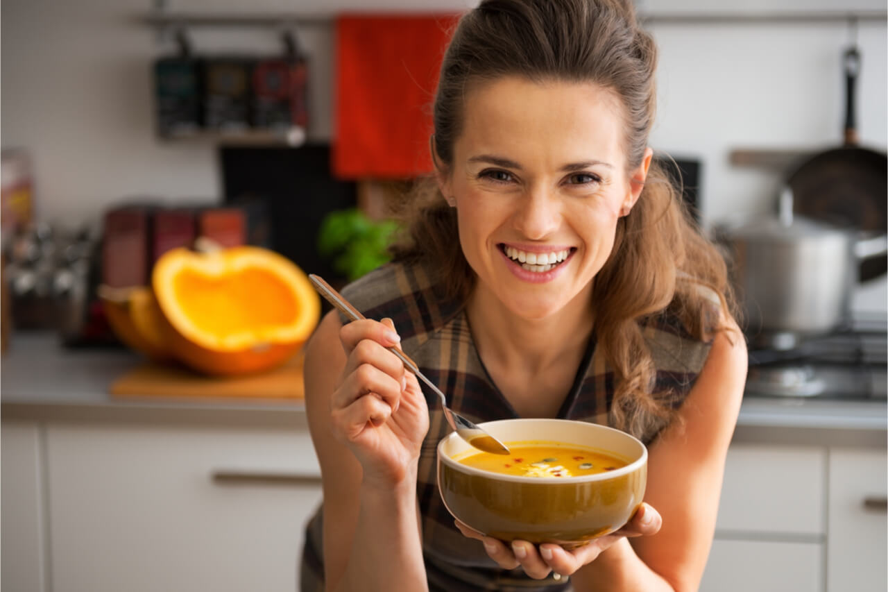 woman eating pumpkin soup